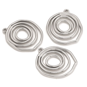 Close-up of three polished silver stainless steel hollow circular pendant components