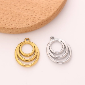 Macro view of nested geometric round stainless steel pendants for DIY jewelry