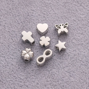 Polished silver stainless steel beads in assorted shapes like hearts and butterflies
