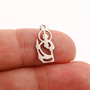 Polished silver stainless steel Jesus silhouette pendant held between fingers
