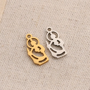 Macro shot of gold and silver Jesus silhouette charms for DIY jewelry making