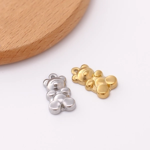 Detailed view of 3D bear-shaped pendants in polished gold and silver stainless steel