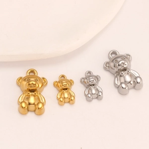 Detailed view of polished 3D teddy bear charms in gold and silver for DIY jewelry