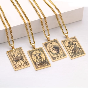 Detailed shot of golden zodiac pendant necklaces featuring Cancer and Taurus designs