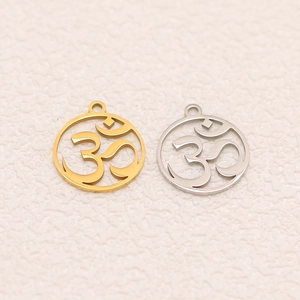 Detailed macro view of laser-cut Om symbols on gold and silver lotus yoga pendants