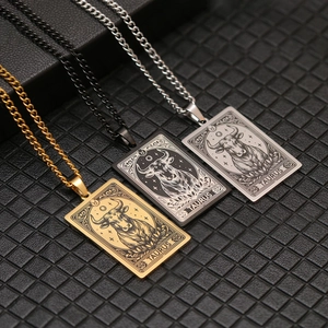Macro detail of Taurus zodiac tarot pendants in gold, black and silver stainless steel