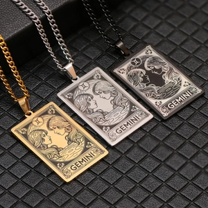 Detailed view of Gemini tarot card pendants in gold, silver and black stainless steel