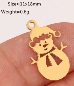 Macro view of a 11x18mm golden snowman pendant in stainless steel for DIY jewelry making