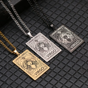 Three Virgo zodiac tarot necklaces in gold, silver, and black finish on black background