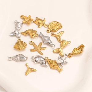 Assorted 14K gold and silver ocean charms including starfish, turtle and shells