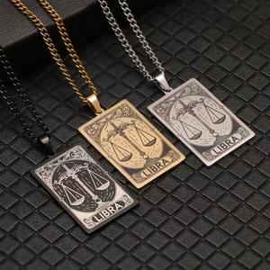 Detail of three-color Libra tarot card pendant necklaces in black, gold, and silver finishes
