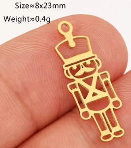 Detailed view of a gold-plated nutcracker soldier charm for DIY jewelry making