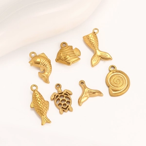 Detailed view of 14K gold-plated stainless steel marine pendants on a white background