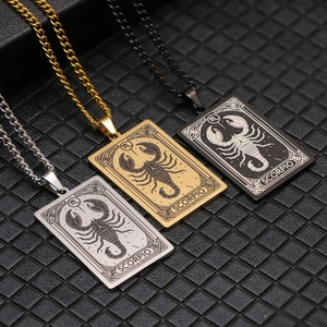 Macro detail of Scorpio tarot card necklaces in gold, silver, and black finish on leather