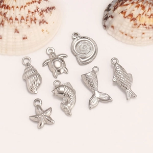 Set of 7 ocean-themed stainless steel charms including starfish, turtle and shells for jewelry