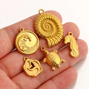 Golden stainless steel ocean pendants set featuring sea turtle, seahorse and whale tail