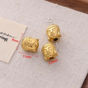 Detailed macro view of 9mm golden Buddha head beads with 2.5mm hole for DIY jewelry