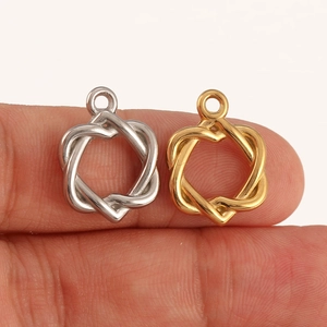 Close-up of interlocking heart pendants in gold and silver finish for DIY jewelry