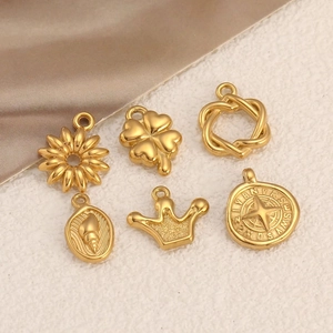 Set of 6 gold stainless steel pendants featuring sun, clover, shell, and compass designs