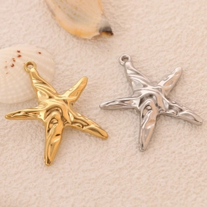 Macro view of starfish charms in gold and silver finishes for ocean theme DIY jewelry