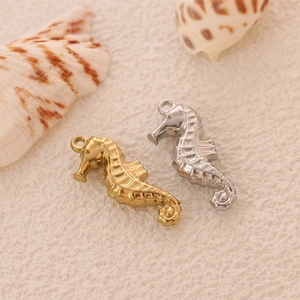 Macro detail of gold and silver seahorse pendants for DIY ocean-themed jewelry
