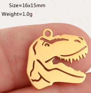 Detailed view of a golden stainless steel T-Rex skull pendant measuring 16x15mm