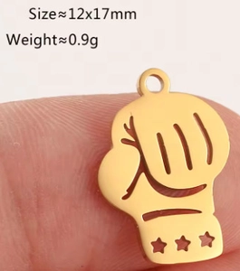 Detailed macro view of gold-tone boxing glove pendant with star cutouts and dimensions