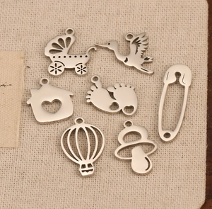 Polished stainless steel baby-themed pendants including pacifier, footprints, and stroller