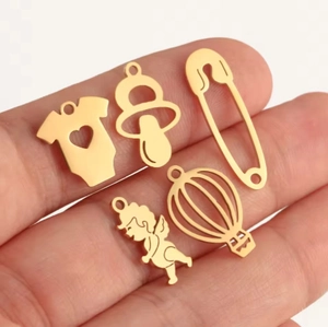 Golden stainless steel baby themed charms including pacifier and baby onesie for DIY jewelry