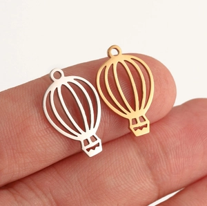 Close-up of hot air balloon pendant charms in gold and silver for DIY jewelry
