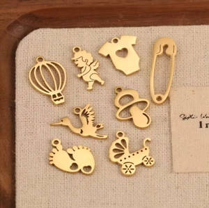 Golden stainless steel baby charms including pacifier and footprint for DIY necklaces