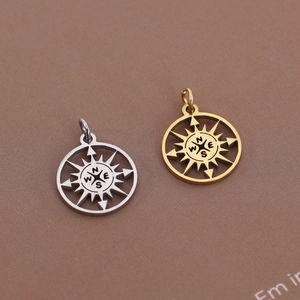 Detail of hollow compass pendants in gold and silver steel for necklaces and bracelets