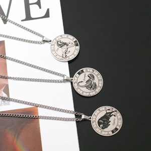 Detailed close-up of rotating zodiac pendant necklaces in polished stainless steel finish
