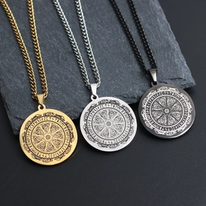 Gros plan des runes viking sur pendentifs ronds en acier doré, argenté et noir