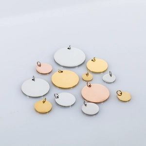 Close-up of DIY stainless steel round dog tag pendants in silver, gold and rose gold