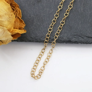 Macro detail of gold plated stainless steel O-chain for DIY jewelry making accessories