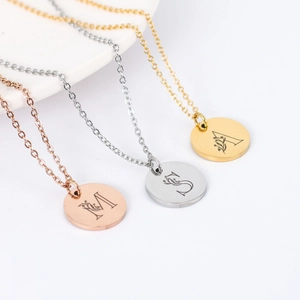 Polished stainless steel letter pendants with floral texture in rose gold, silver, and gold