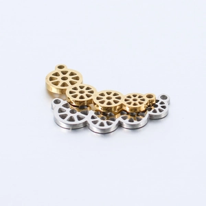 Detail of mirror polished geometric hollow pendants in gold and silver stainless steel