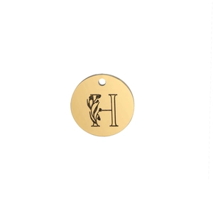 Close-up of 15mm polished gold round pendant featuring an engraved letter H with floral motifs