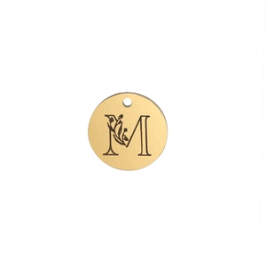 Detailed close-up of a 15mm gold-finished steel pendant with floral letter M engraving