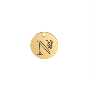 Detailed view of golden 15mm round pendant with engraved letter N and floral pattern