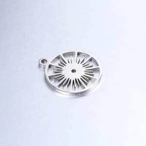 Detail of silver round sunburst pendant with hollow gear design in polished stainless steel