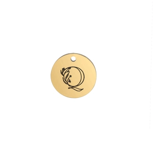 Close-up of polished 15mm gold pendant with engraved letter Q and floral design