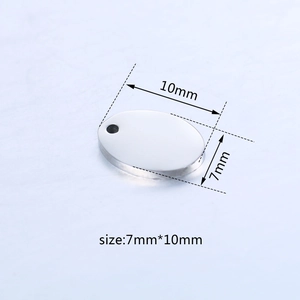 Macro shot of oval stainless steel DIY jewelry tag measuring 7mm by 10mm with small hole