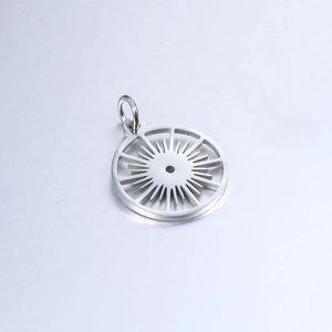Macro detail of a silver stainless steel hollow sunburst pendant with metallic luster