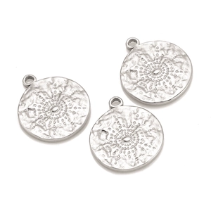 Detailed view of three circular stainless steel pendants with sunburst texture and bale
