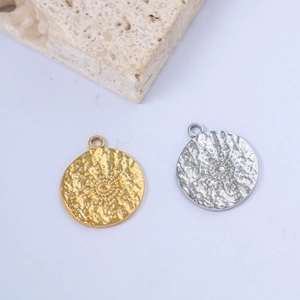 Detailed view of hammered sunburst round pendants in gold and silver stainless steel