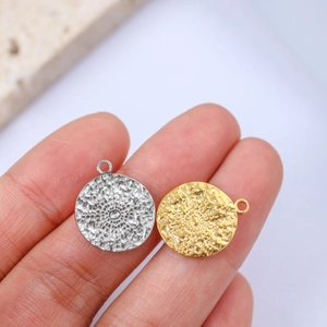 Macro shot of sunburst textured metal charms in gold and silver finish for DIY jewelry