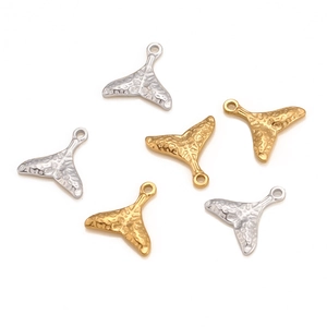 Detailed view of hammered mermaid tail pendants in gold and silver finish for DIY jewelry