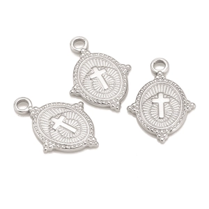 Macro shot of three silver stainless steel oval pendants with embossed cross detail